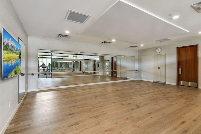 exercise room featuring light hardwood / wood-style floors