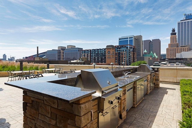 view of patio / terrace with area for grilling, an outdoor kitchen, and a wet bar