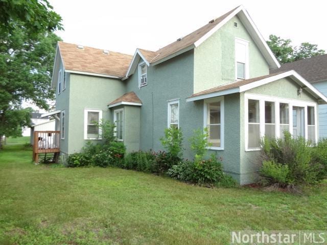 back of house with a lawn