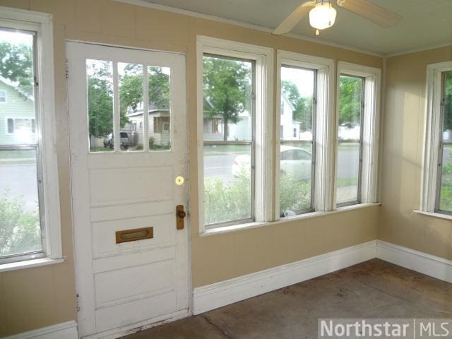 doorway featuring plenty of natural light and ceiling fan