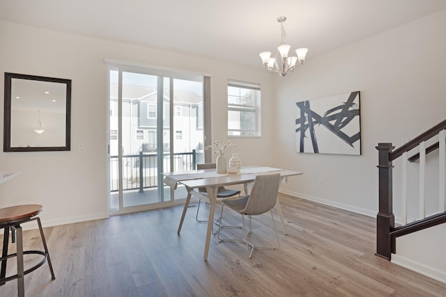 dining area featuring a notable chandelier and light hardwood / wood-style floors