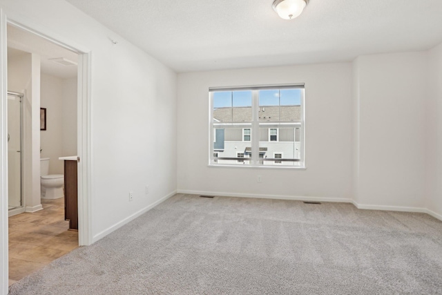 empty room featuring light colored carpet