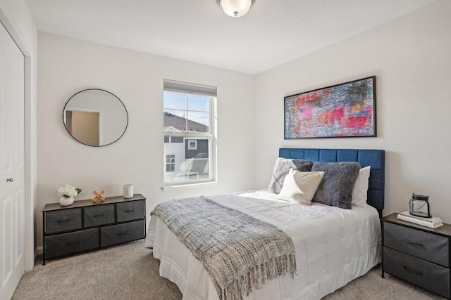 bedroom with light carpet and a closet