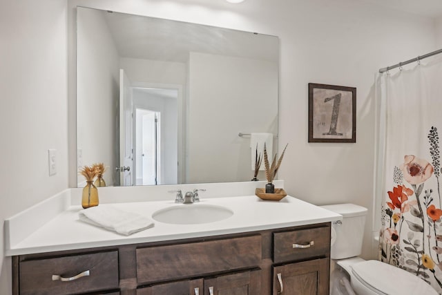 bathroom with vanity and toilet