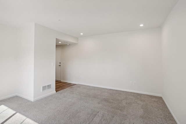 unfurnished room with light carpet