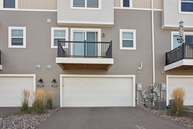 rear view of house featuring central AC