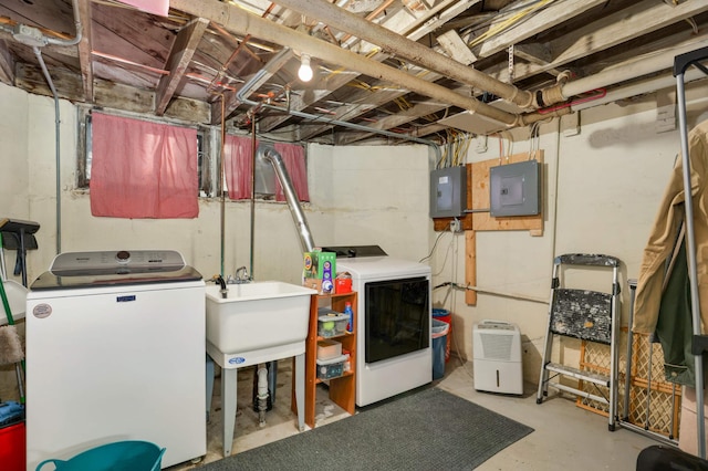 basement with sink, electric panel, and independent washer and dryer