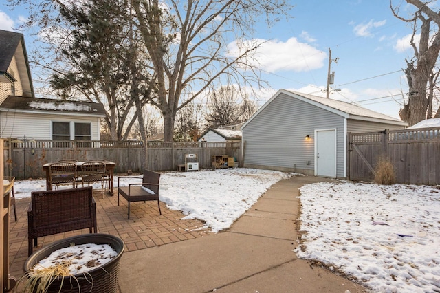 snow covered patio featuring an outdoor structure