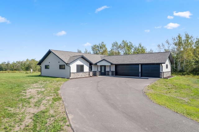 ranch-style home featuring a garage and a front yard