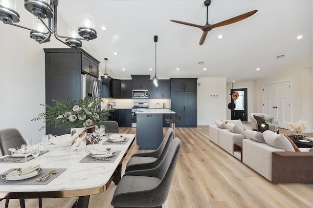 dining area featuring ceiling fan and light hardwood / wood-style flooring