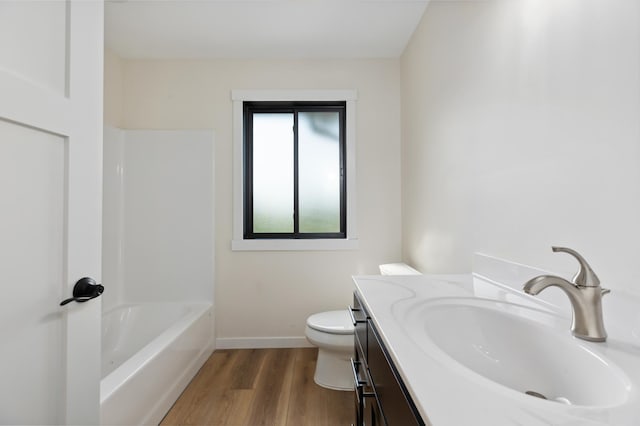 bathroom with hardwood / wood-style flooring, toilet, and vanity