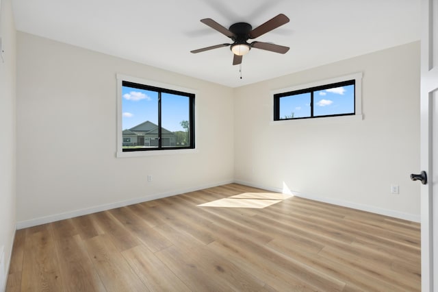 spare room with ceiling fan and light wood-type flooring