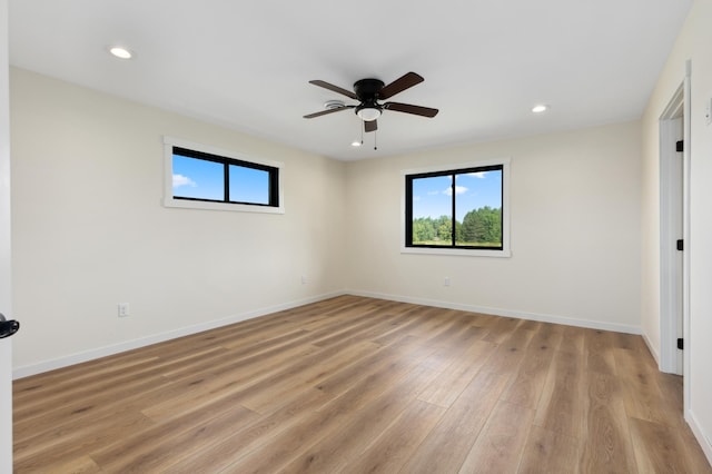 spare room with light wood-type flooring and ceiling fan