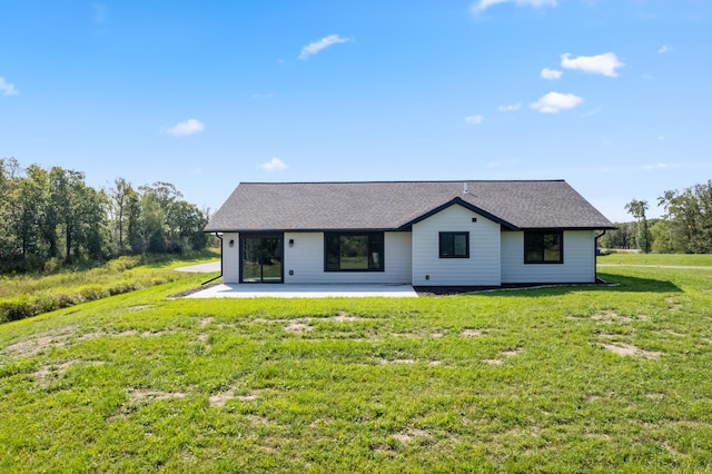 back of house featuring a lawn and a patio