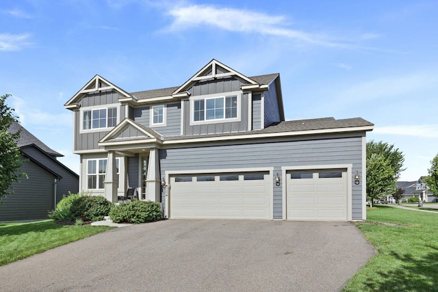 view of front of property with a garage and a front lawn