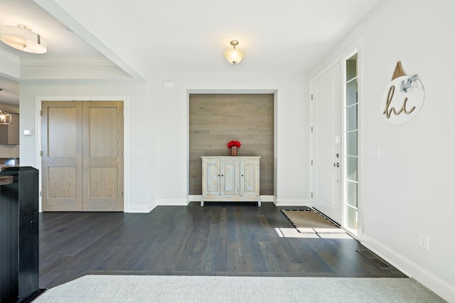 entryway with crown molding and dark hardwood / wood-style floors