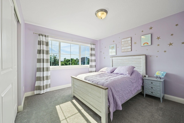 bedroom with dark colored carpet