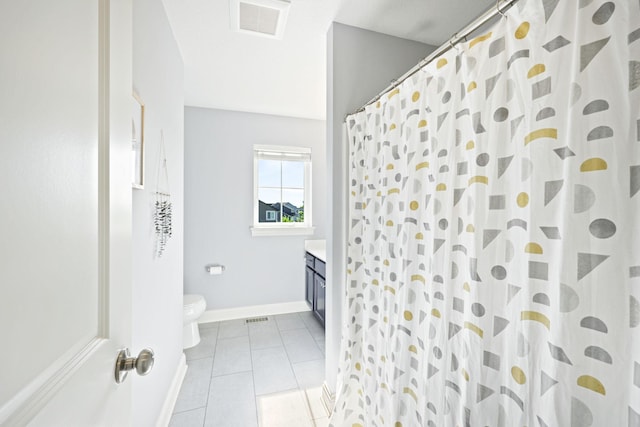 bathroom with toilet, vanity, a shower with shower curtain, and tile patterned flooring