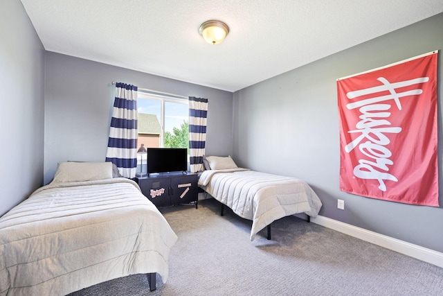 bedroom featuring carpet and a textured ceiling