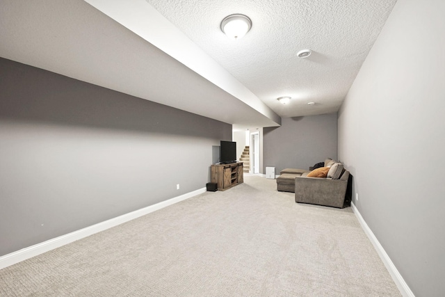 unfurnished room with light colored carpet and a textured ceiling