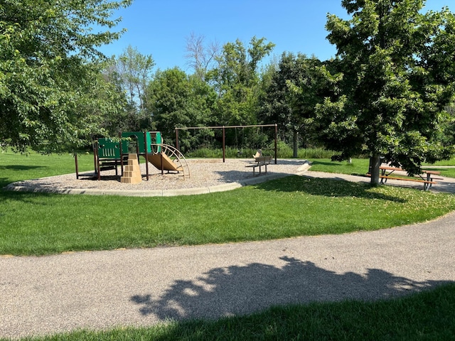 view of playground with a lawn