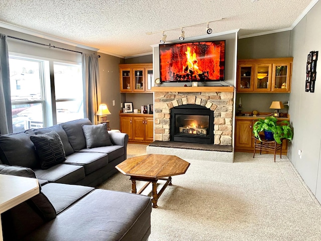 carpeted living room with a stone fireplace, ornamental molding, and a textured ceiling