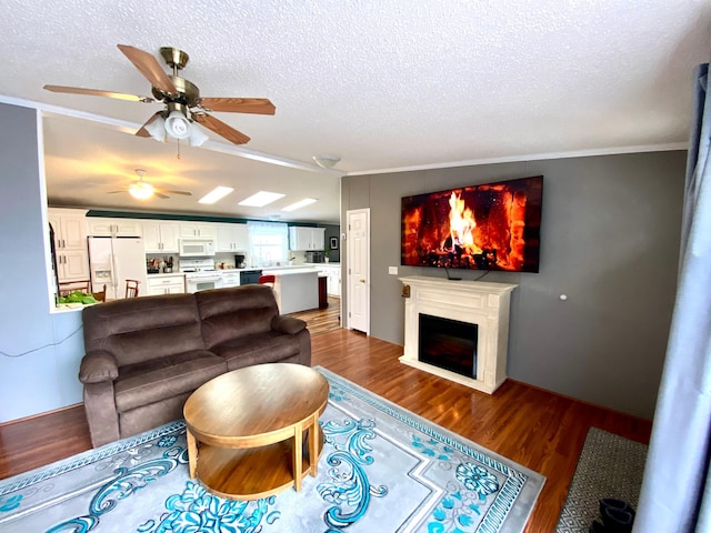 living room with vaulted ceiling, dark hardwood / wood-style flooring, ornamental molding, and a textured ceiling