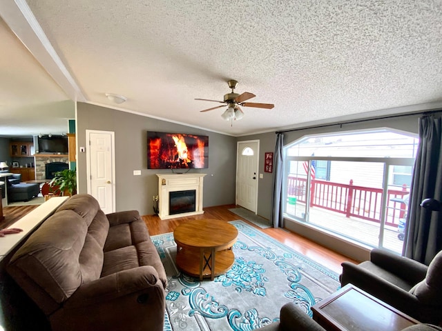 living room featuring ornamental molding, lofted ceiling, and hardwood / wood-style floors