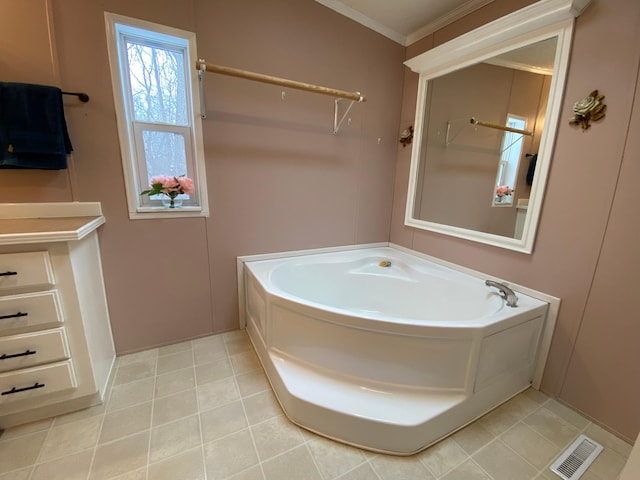 bathroom with crown molding, tile patterned flooring, and a tub