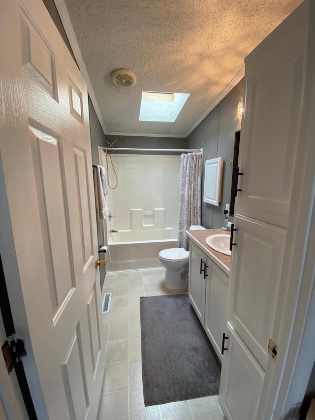 full bathroom featuring vanity, toilet, a skylight, and a textured ceiling