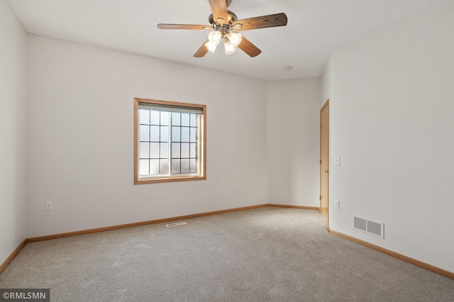 unfurnished room with light colored carpet and ceiling fan