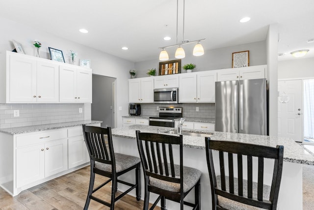 kitchen with white cabinetry, sink, and appliances with stainless steel finishes