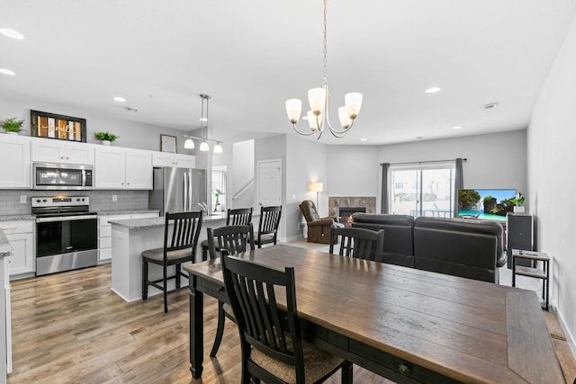 dining room featuring an inviting chandelier and light wood-type flooring