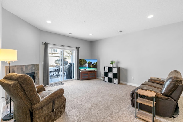 carpeted living room with a tile fireplace