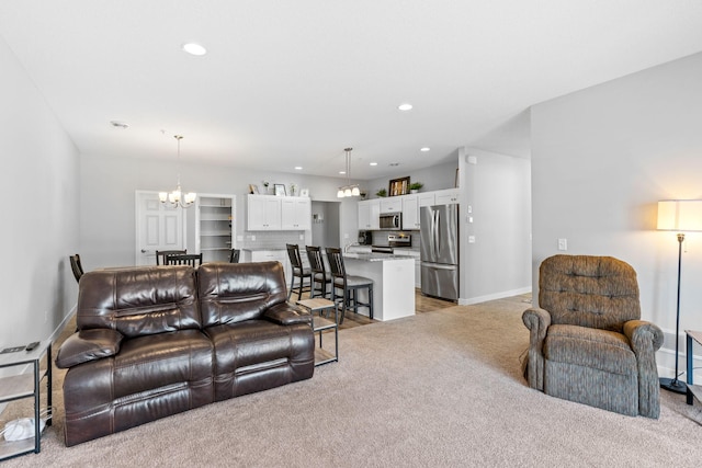 living room featuring light colored carpet and a notable chandelier