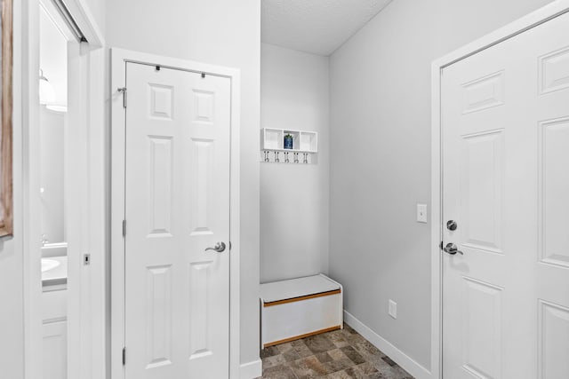 mudroom with a textured ceiling