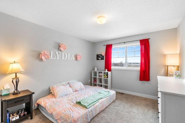 bedroom with carpet flooring and a textured ceiling