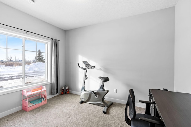 workout room featuring carpet floors and a textured ceiling