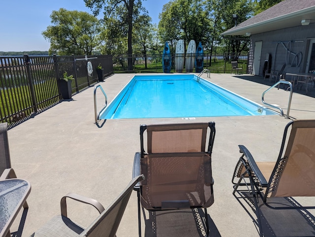 community pool featuring fence and a patio