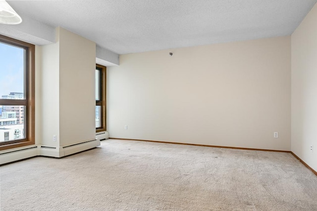 433 7th St Unit 1628, Minneapolis, MN 55415 - empty room featuring plenty of natural light, light colored carpet, a textured ceiling, baseboards, and a baseboard radiator