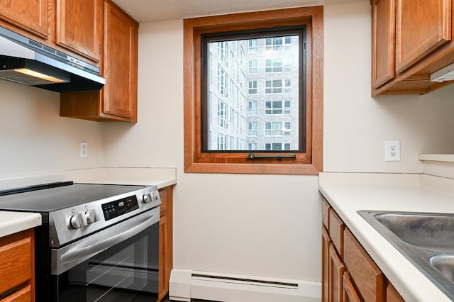 433 7th St Unit 1628, Minneapolis, MN 55415 - kitchen featuring stainless steel range with electric stovetop, under cabinet range hood, baseboard heating, brown cabinets, and light countertops