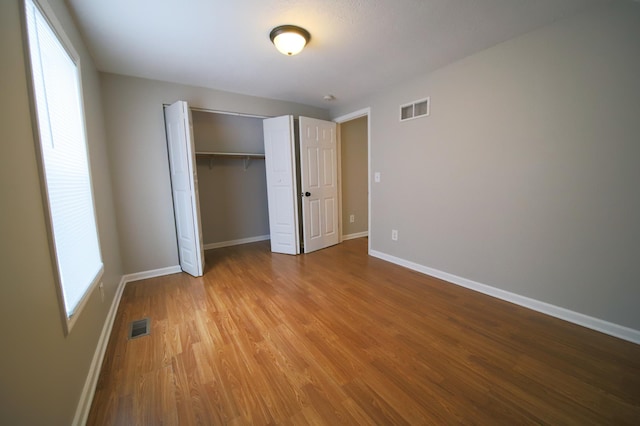 unfurnished bedroom featuring a closet and light hardwood / wood-style flooring