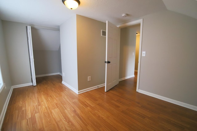 interior space featuring vaulted ceiling and hardwood / wood-style floors