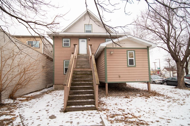 view of snow covered rear of property