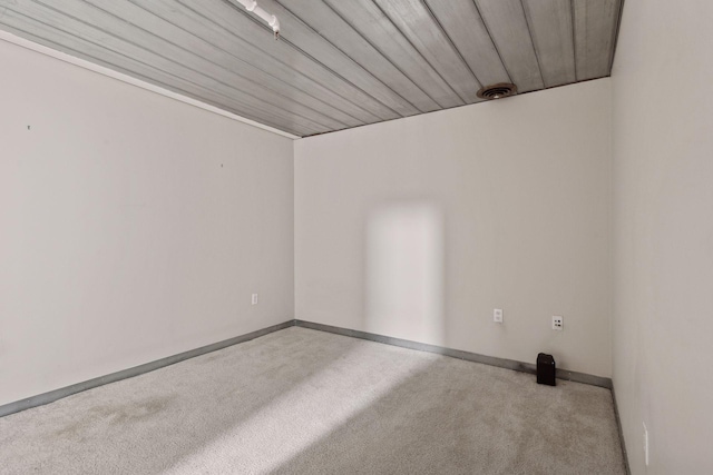 empty room featuring wood ceiling