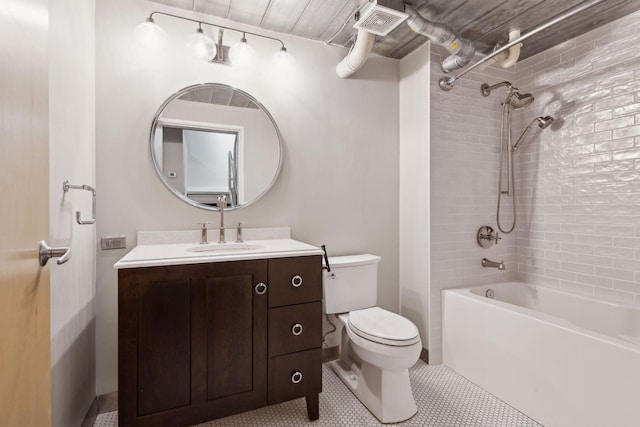 full bathroom featuring tiled shower / bath, vanity, toilet, and tile patterned floors