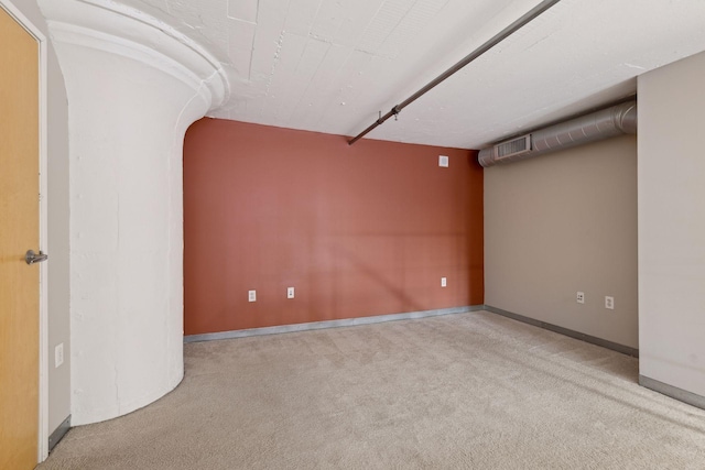 spare room featuring light colored carpet