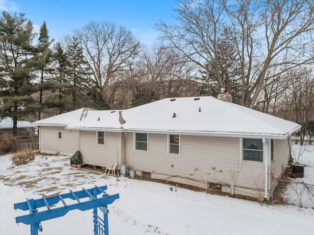 view of snow covered back of property