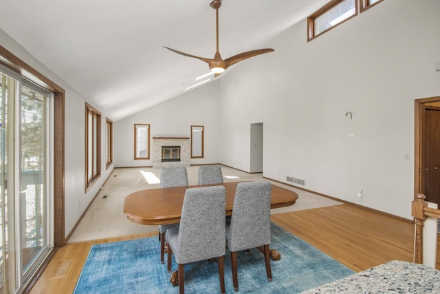 dining area with ceiling fan, light hardwood / wood-style flooring, and lofted ceiling