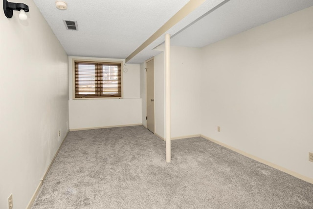 interior space with a textured ceiling and light colored carpet